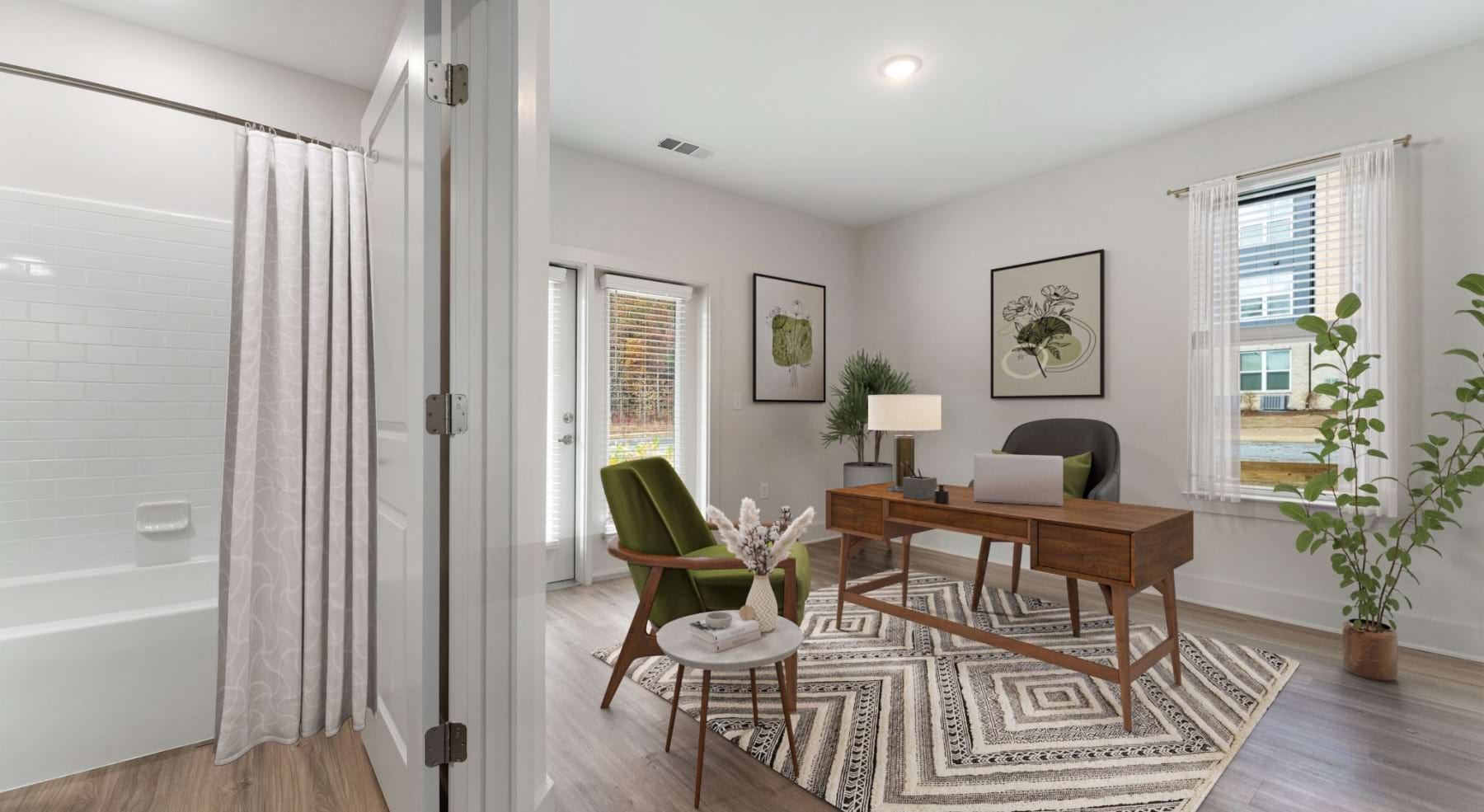 A bedroom with wood floors windows and a bathroom close by