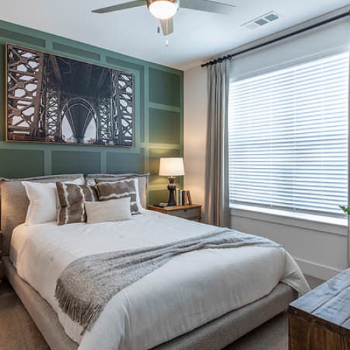 carpeted bedroom with large window